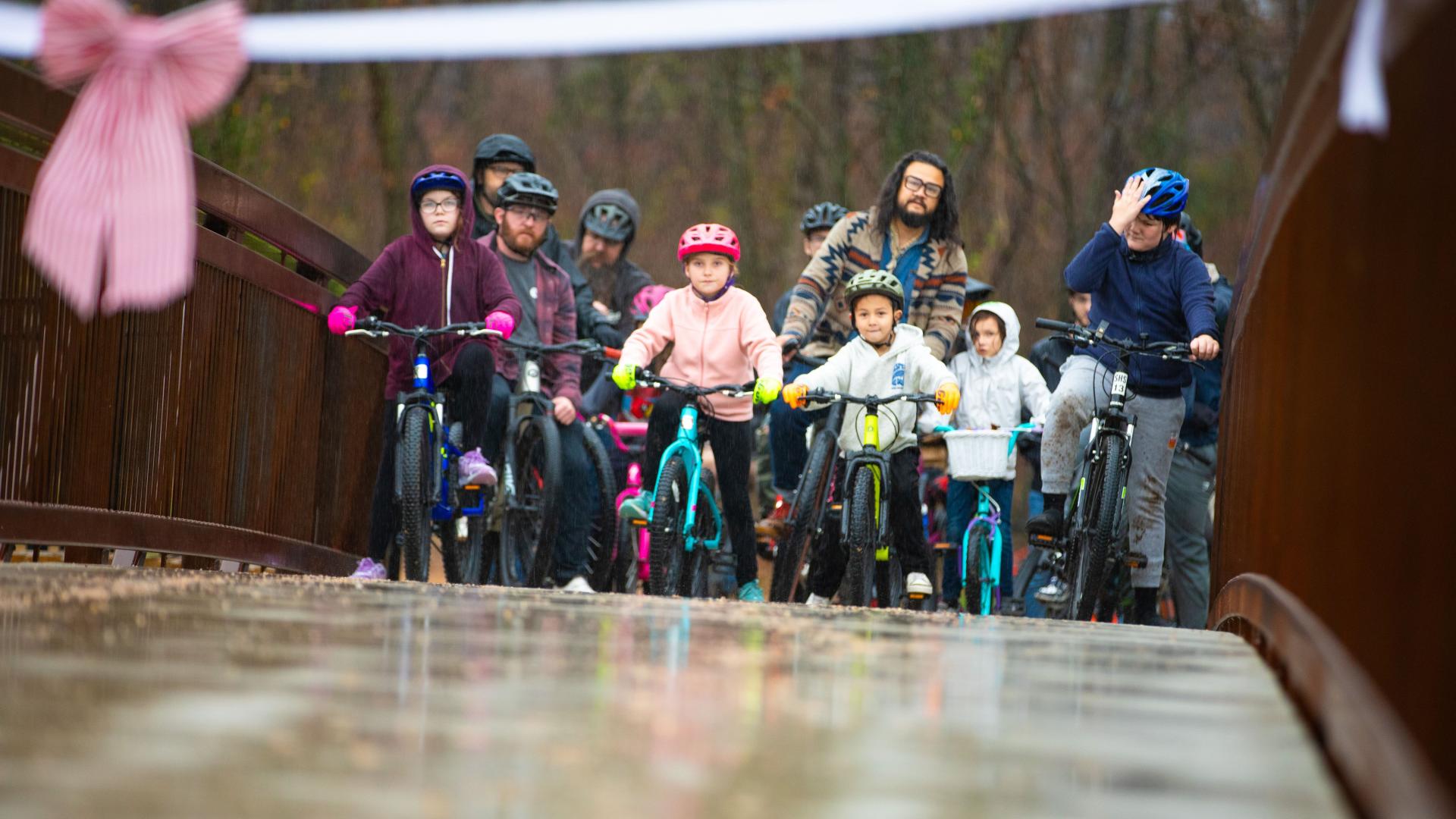 Riders ready to break the ribbon in the rain at MOmentum Bike Park