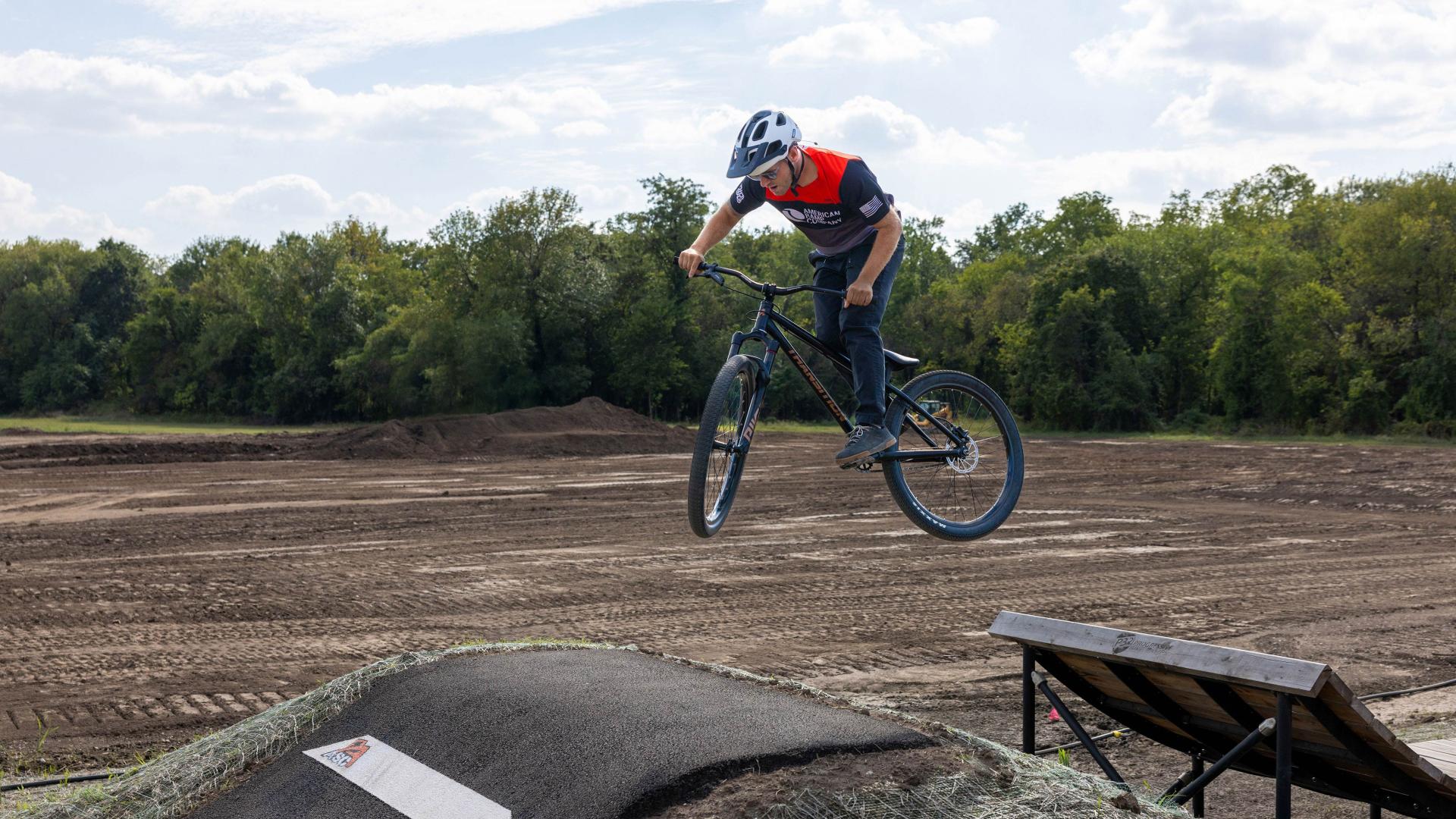Rider jumping between ramps on jump line