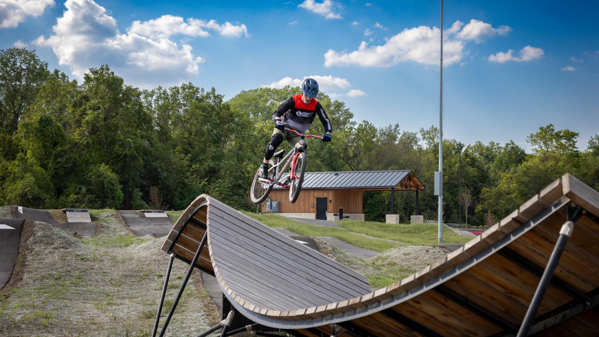 Rider jumping onto expert jump line ramp