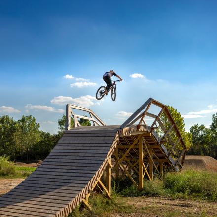 Bike rider catching big air on the 3rd Law Flyover at MOmentum