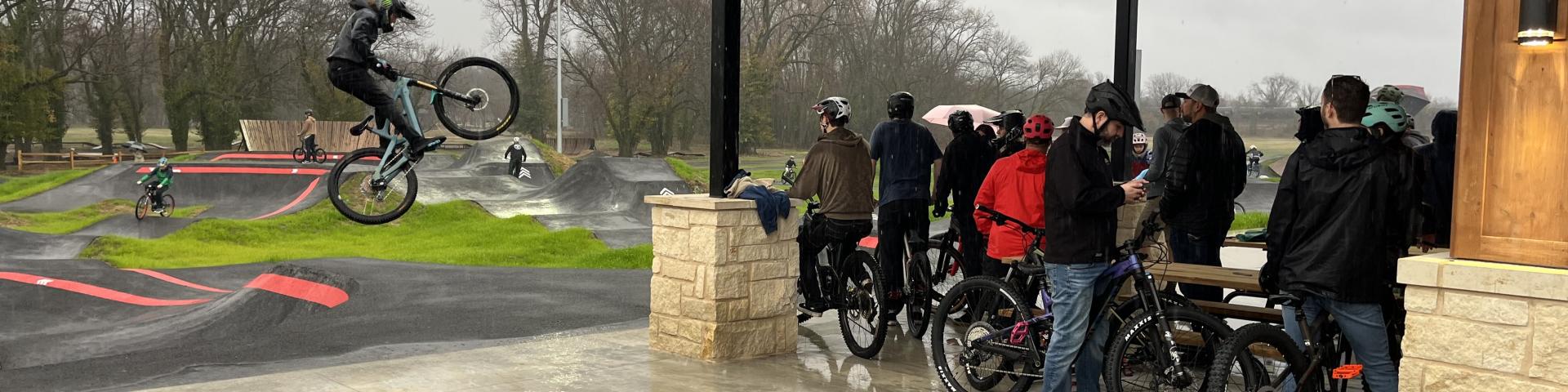 Opening day crowd waiting to ride pump track in the rain