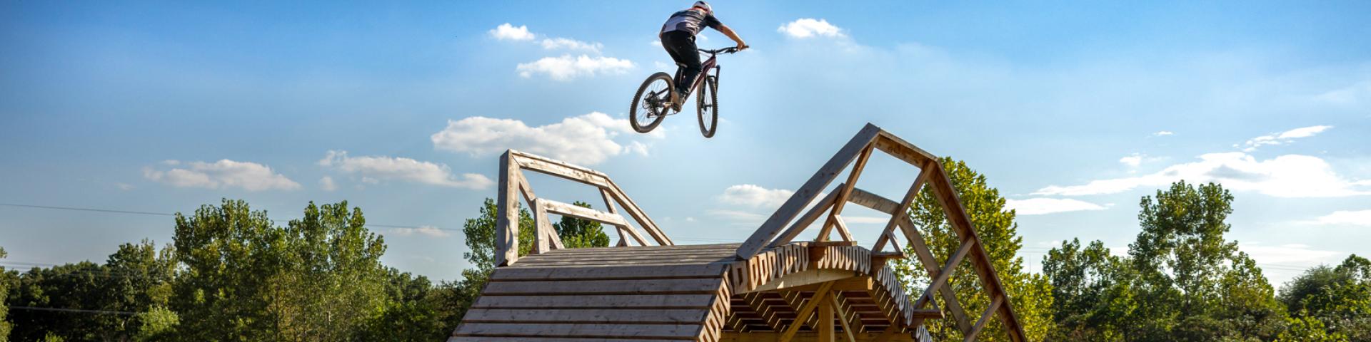 Bike rider catching big air on the 3rd Law Flyover at MOmentum